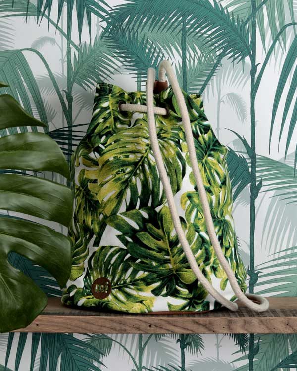 Tropical palm print back pack against tropical wall paper